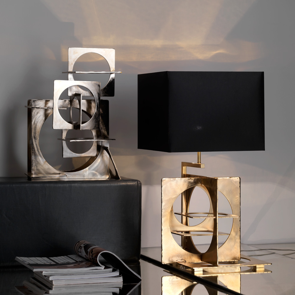 Table lamp in hand emery and engraved steel, aged gold finish. Black
chintz lampshade with golden inside.